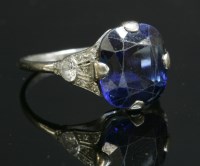 Lot 182 - An Art Deco single stone sapphire ring with diamond set shoulders