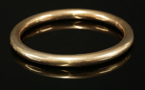 Lot 185 - A 9ct gold hollow round section slave bangle