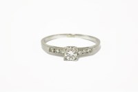 Lot 36 - A single stone diamond ring with six brilliant cut diamonds to shoulders