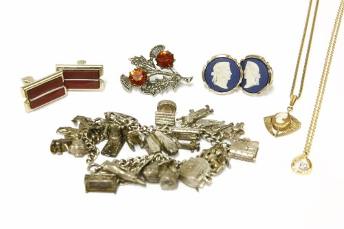 Lot 60 - A silver charm bracelet with assorted silver charms