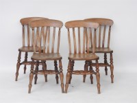 Lot 528 - A set of four late 19th century chairs lathe back beechwood kitchen chairs with solid elm seats on stretchered turned supports