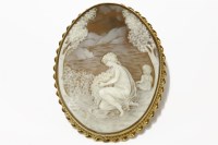 Lot 38 - A 9ct gold mounted shell cameo brooch of a young maiden in a landscape setting