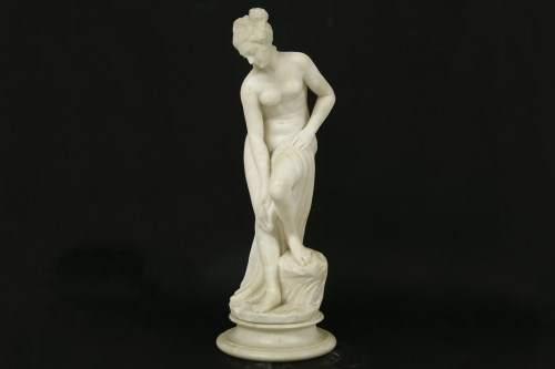 Lot 308 - An early 20th century carved figure of a female on a stand