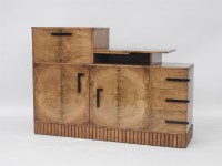 Lot 472 - An Art Deco walnut dining room suite