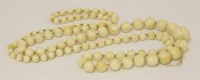 Lot 515 - An ivory graduated bead necklace