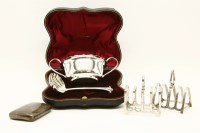 Lot 147 - A silver cased twin handled sugar bowl and spoon