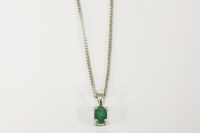 Lot 15 - An 18ct white gold single stone oval cut emerald pendant