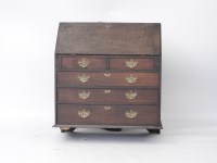 Lot 554 - A George III oak bureau