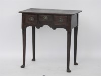 Lot 565 - A 19th century walnut lowboy