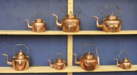 Lot 470 - Seven graduated copper and brass kettles