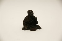 Lot 169 - A small Japanese bronze figure of a seated craftsman