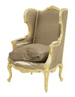 Lot 483 - A Louis XV-style carved and giltwood wing armchair