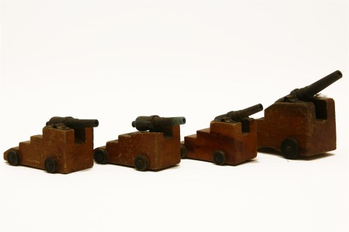 Lot 162 - A set of four miniature cannons on stepped wooden bases and wheels