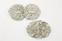 Lot 12 - A silver nurses buckle with pierced openwork decoration of scrolling vines