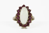 Lot 21 - A 9ct gold oval cabochon opal and ruby cluster ring
