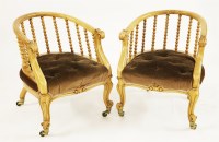 Lot 573 - A pair of Victorian satin walnut tub chairs