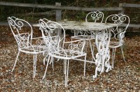 Lot 591 - A wrought iron garden table