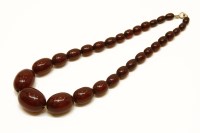 Lot 27 - A single row graduated olive shaped Bakelite bead necklace of oxblood colour