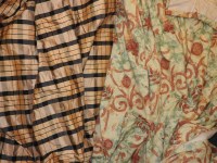 Lot 284 - A pair of gold and black check silk lined and inter lined curtains