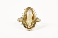 Lot 1058 - A gold single stone citrine ring