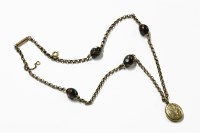 Lot 1049 - A gold belcher link neck chain with Venetian black glass beads and a rolled gold memorial locket
total weight 13.41g