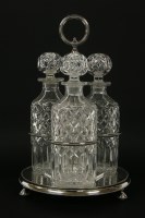Lot 1253 - An early 20th century three bottle decanter stand