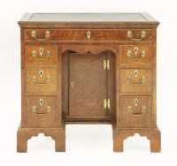 Lot 527 - A George II-style walnut kneehole desk