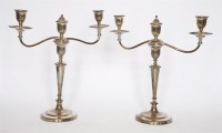 Lot 215 - A pair of close-plated three-light candelabra