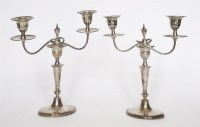 Lot 216 - A pair of sheet silver two-light table candelabra