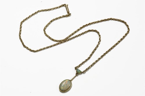 Lot 1039 - An Edwardian gold milligrain set oval cut opal drop pendant