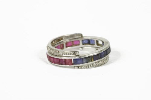 Lot 1052 - A square cut sapphire and ruby eternity ring