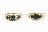 Lot 1002 - A 9ct gold graduated three stone sapphire with pairs of diamond set points ring