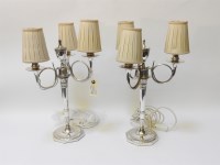 Lot 1265 - A pair of electroplated three branch candelabra