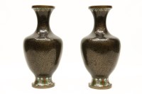 Lot 1402 - A pair of cloisonne vases with black ground and lappet boarders each 31cm high