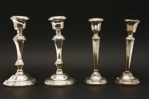 Lot 1174 - Two pairs of silver candlesticks (a/f)