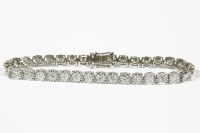 Lot 1094 - An 18ct white gold diamond set line bracelet