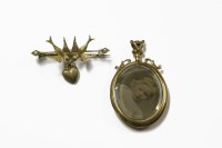 Lot 1059 - A gold Swallow brooch with a later heart shaped charm