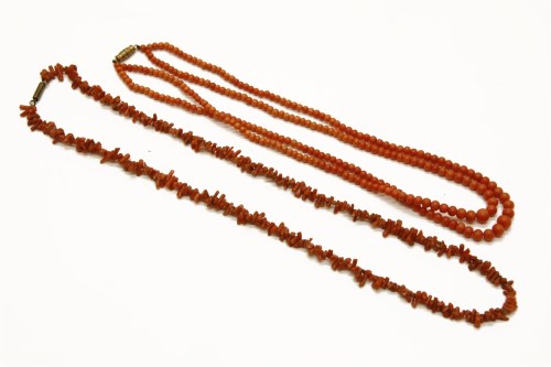 Lot 1010 - A two row graduated coral bead necklace together with a single row twig coral bead necklace