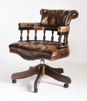 Lot 50 - A modern mahogany swivel office chair in the Victorian style