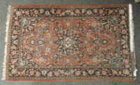 Lot 1720 - A Persian design rug with navy and red fields