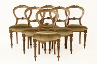 Lot 600 - A set of six late Victorian mahogany balloon back dining chairs with stuffover seats on fluted turned supports (6)