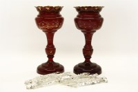 Lot 243 - A pair of late Victorian cranberry glass lustres