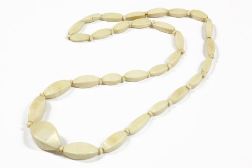 Lot 33 - A late 19th century single row graduated faceted navette ivory bead necklace