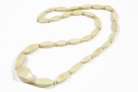 Lot 33 - A late 19th century single row graduated faceted navette ivory bead necklace
