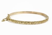 Lot 38H - A 9ct gold hinged bangle with repoussé top section