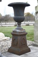 Lot 727 - A cast iron campana form garden urn