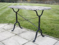 Lot 730 - A cast iron garden table