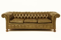 Lot 595 - A three seater green leather Chesterfield