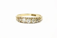 Lot 221 - A gold graduated five stone diamond carved head ring
