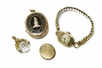 Lot 257 - A gold memorial locket with black enamel decoration 'Not lost but gone before'